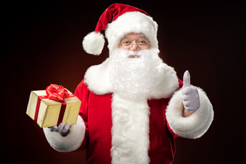 Santa Claus with gift box in hand