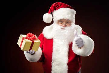 Santa Claus with gift box in hand