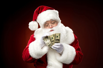 Santa Claus counting dollar banknotes