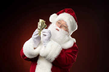 Santa Claus counting dollar banknotes