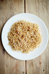 Directly above view of fresh low-calorie sprouting seeds laid out on white plate, healthy ready to eat snack