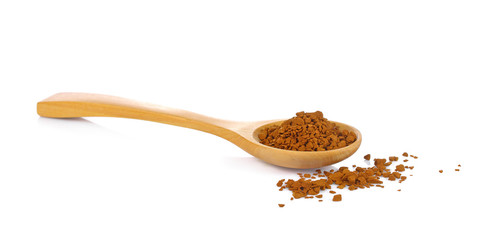 Granules of instant coffee in a wooden spoon isolated