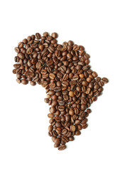 Closeup above view shot: heap of rich brown freshly roasted coffee seeds scattered on white table in shape of African continent