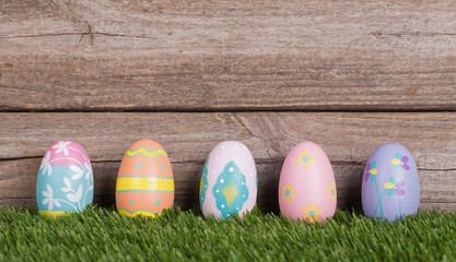 Row of Colorful Easter Eggs Against a Wooden Background