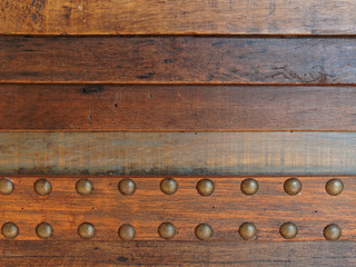 Dark brown vintage wooden stripped background with brass buttons