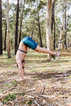 Man doing suspension training outdoors