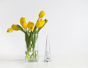 Yellow tulips and glass cone