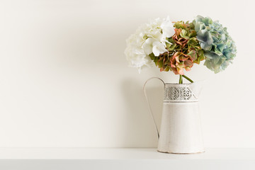 Flowers in Pitcher Vase on White Shelving