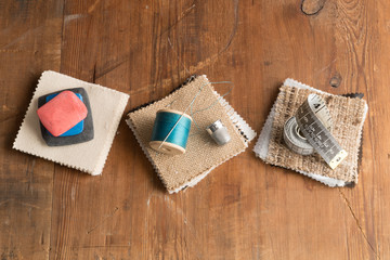 Thread and Needle, Tape Measure and Chalk on Fabric Swatches