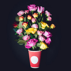 Violet and yellow roses put in red paper cup