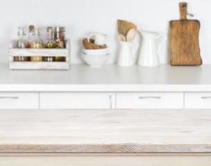 Fototapeta na wymiar Light wood table with bokeh image of kitchen counter interior