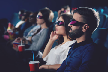 Two friends watching movie in 3d glasses.