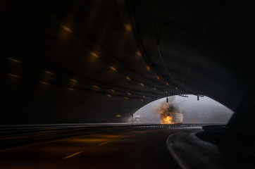 Truck on fire under a tunnel