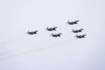 Air show in the sky above the Krasnodar airport flight school. Airshow in honor of Defender of the Fatherland. MiG-29 in the sky.