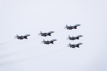 Air show in the sky above the Krasnodar airport flight school. Airshow in honor of Defender of the Fatherland. MiG-29 in the sky.