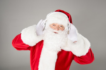 Santa Claus listening music with headphones
