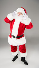 Santa Claus listening music with headphones