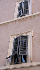 Fototapeta na wymiar half-open window, typical jalousie in Rome, vintage architecture
