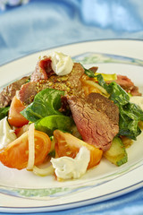 meat salad with green tomatoes on the plate blue background lot of food recipes