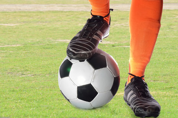 Boy is playing soccer in a ground