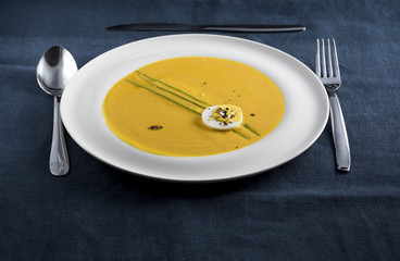 cream of pumpkin soup with boiled egg and chives pepper