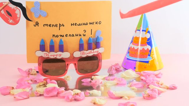 Birthday wishes with postcard, paper sunglasses and hat and birthday accessories