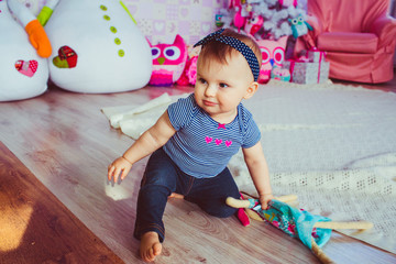 Fototapeta premium Curious little girl creeps around the carpet