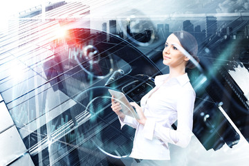 Attractive business lady working on tablet . Mixed media