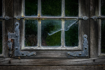 The  window of an old,wooden farmhouse