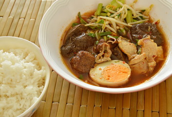 boiled pork entrails topping egg in brown soup eat couple with rice