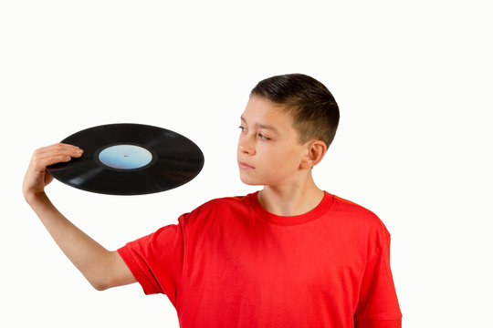 Teenage boy looking at a vinyl record
