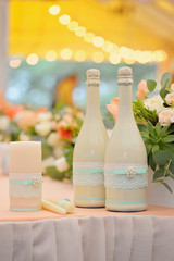 Two decorated bottles of champagne on the wedding celebration