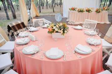 Wedding guest table decorated with bouquet and settings