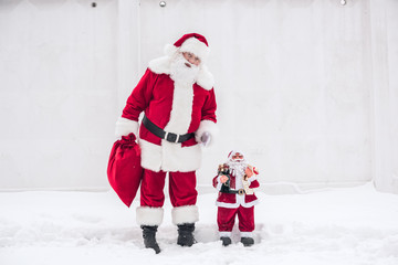 Santa Claus standing with Little Santa