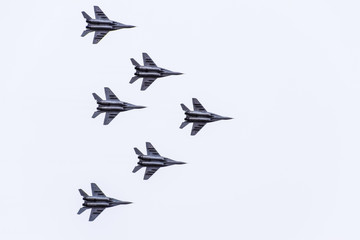 Air show in the sky above the Krasnodar airport flight school. Airshow in honor of Defender of the Fatherland. MiG-29 in the sky.