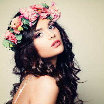 Beautiful Model Woman with Perfect Makeup, Long Curly Hair and Wreath of Flowers