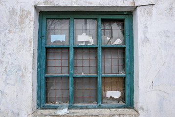 Fototapeta na wymiar Old broken window with rusty iron bars