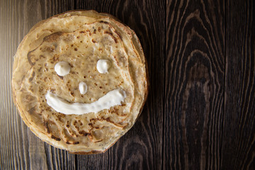 Fried tasty smiling pancakes
