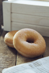 Two donuts on wooden table