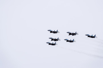 Air show in the sky above the Krasnodar airport flight school. Airshow in honor of Defender of the Fatherland. MiG-29 in the sky.