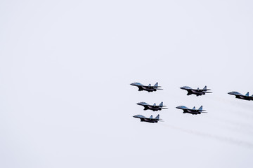Air show in the sky above the Krasnodar airport flight school. Airshow in honor of Defender of the Fatherland. MiG-29 in the sky.