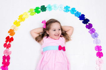 Little girl with colorful bow. Hair accessory