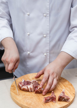 Chef Cutting Raw Meat on The Wood Block.