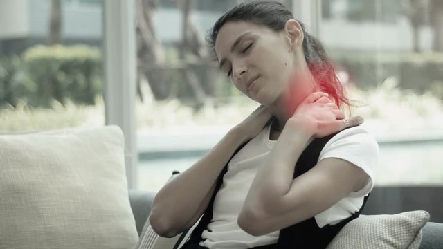 Woman massaging her neck and shoulder from an ache or pain. red circles as a point of pain