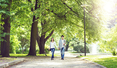 Fototapeta na wymiar Young beautiful couple walking in the park. Love, relationship, dating: concept.