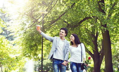 Naklejka na ściany i meble Young beautiful couple walking in the park. Love, relationship, dating: concept.