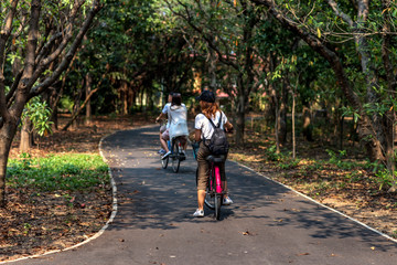 Obraz premium A girl ride bicycle in the park