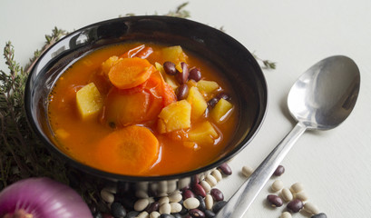tomato soup with beans on white background.