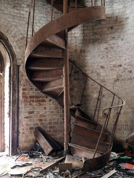 Rusty old staircase spiral. A lot of garbage. The brick walls of the tower