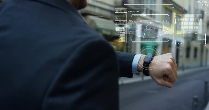 A man at the phone appears in hologram, futuristic clock and technology, a world as the connection symbol. Concept: network, communication, family,technology,augmented reality and immersive technology
